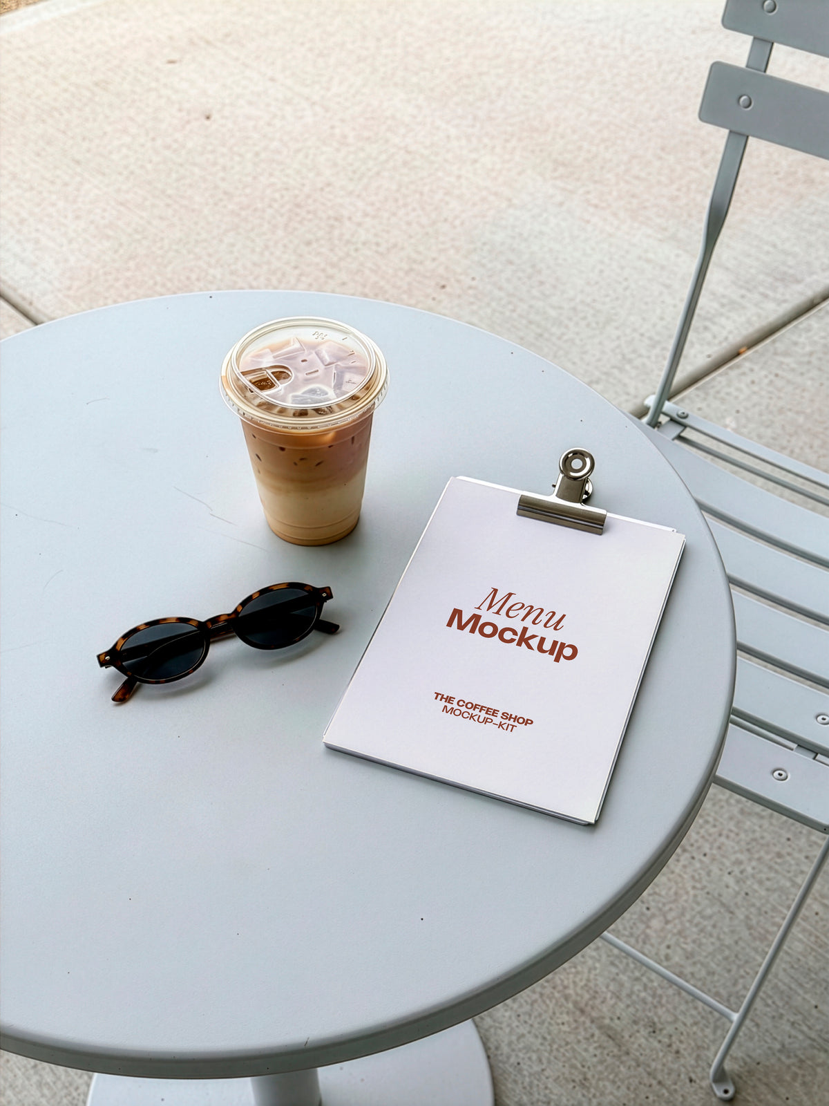 Clipboard menu mockup styled on a café table with iced coffee and sunglasses. Blank clipboard menu mockup ready for your restaurant or café branding design. Menu mockup, clipboard mockup, stationery mockup, coffee shop mockup, restaurant mockup, café mockup, high quality mockup, PSD file.