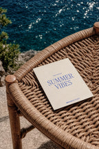 A5 print mockup PSD on a woven rattan chair overlooking the sea