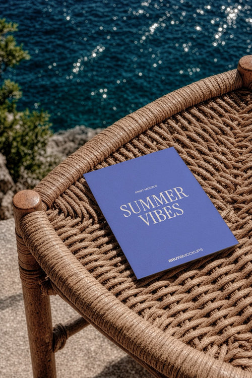 A5 print mockup PSD on a woven rattan chair overlooking the sea
