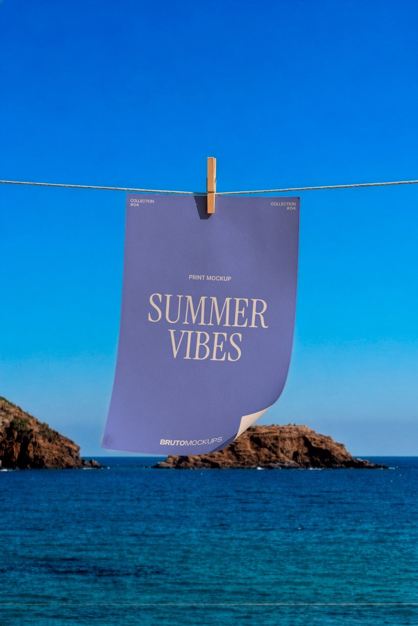 Print poster mockup PSD hanging from a clothesline over the ocean with a rocky coastline