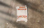Real photo taped print poster mockup on textured wall with natural shadows (paper grain visible)