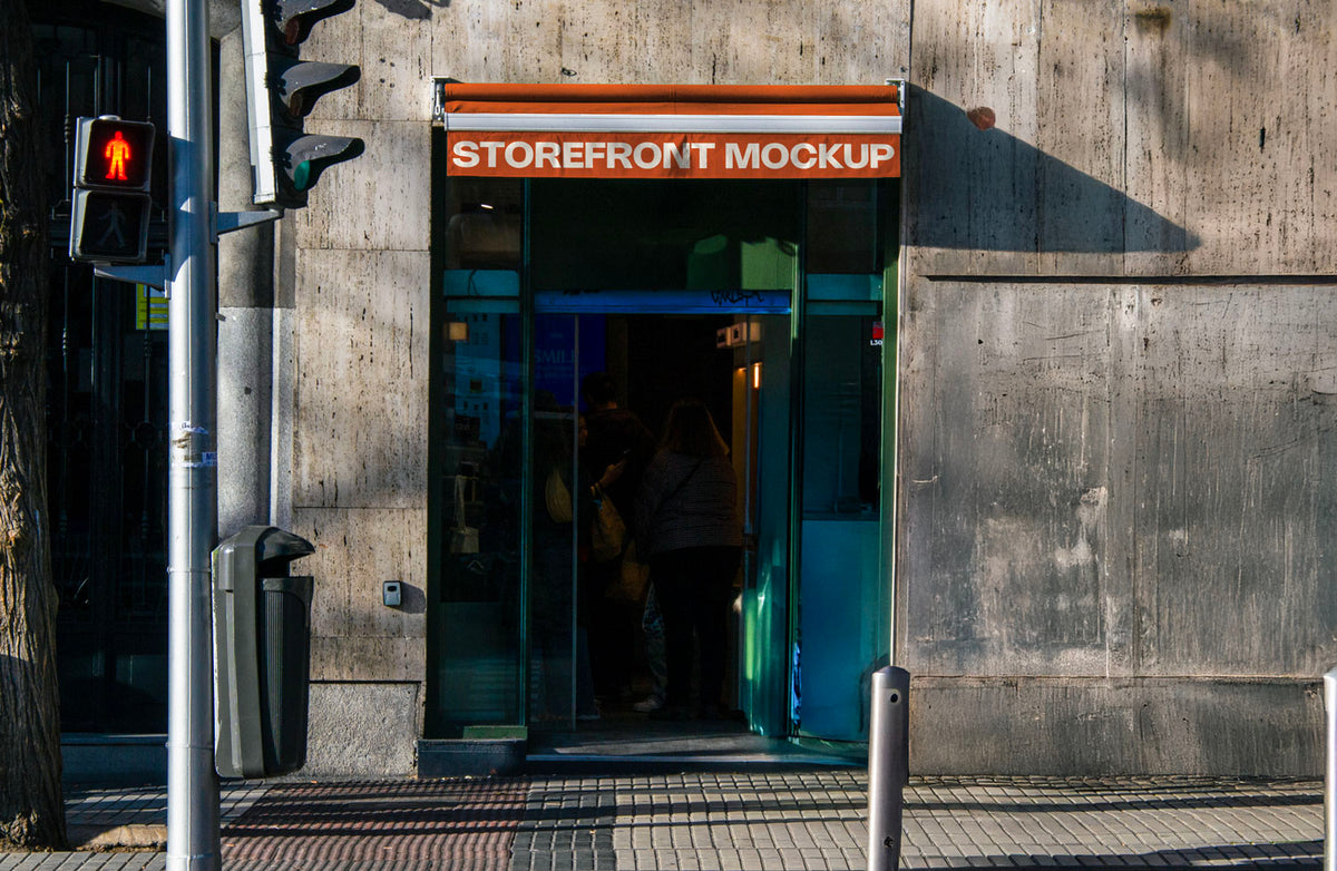 Real photo storefront sign/awning mockup above shop entrance with natural light and shadows