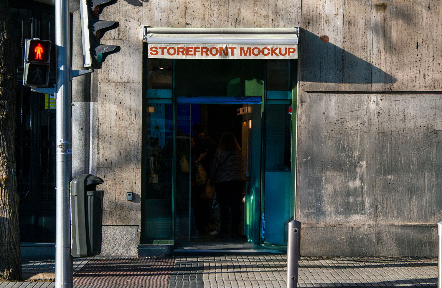Real photo storefront sign/awning mockup above shop entrance with natural light and shadows