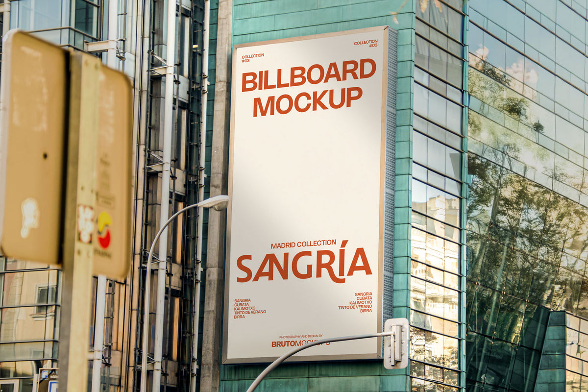 Real photo billboard mockup PSD on glass building with city reflections
