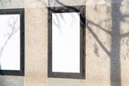 Real photo street poster frame mockup on stone wall with natural shadows