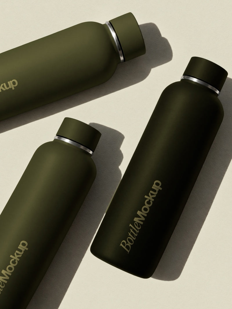 Water bottle mockup with three matte olive insulated bottles on a cream surface with sunlit shadows. Insulated bottle mockup for pilates and wellness brands. Water bottle mockup, thermal bottle mockup, drinkware mockup, pilates mockup, wellness mockup, merch mockup, high quality mockup, PSD file.