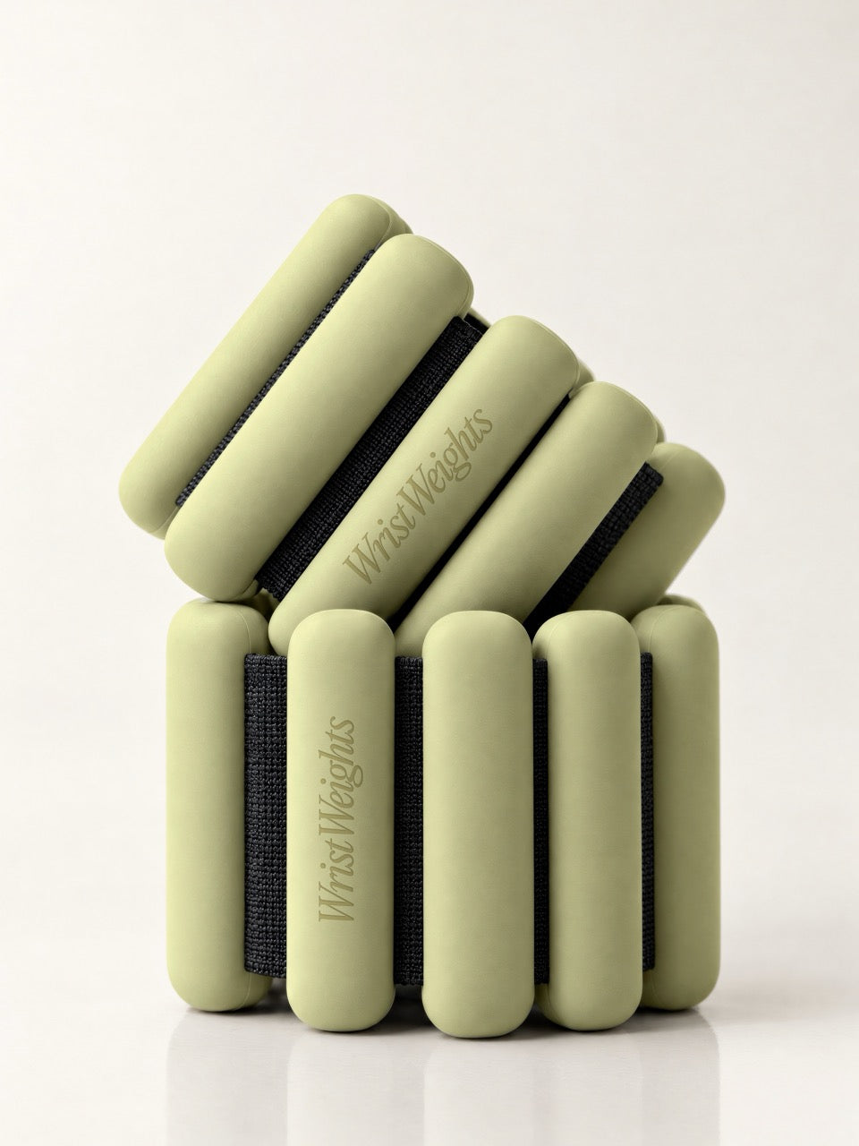 Wrist weights mockup with two stacked sage green bangle weights on a white background. Pilates wrist weights mockup for fitness brands. Wrist weights mockup, bangle weights mockup, ankle weights mockup, pilates mockup, fitness mockup, merch mockup, high quality mockup, PSD file.