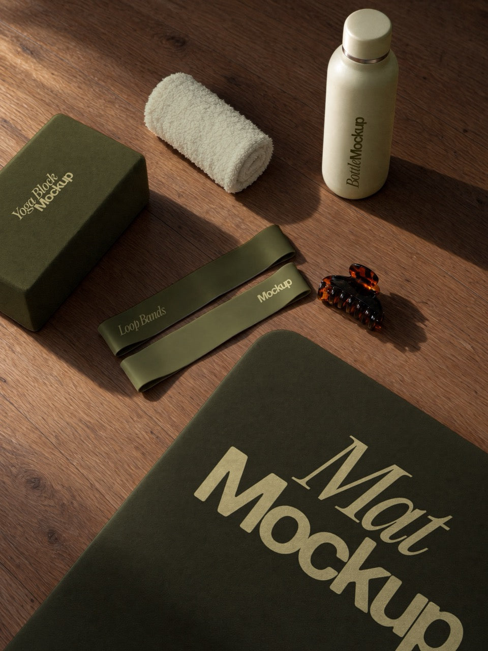 Pilates flat lay mockup on a wooden floor with a yoga block, loop bands, a bottle, a towel and a mat. Wellness merch mockup scene. Flat lay mockup, yoga block mockup, resistance band mockup, yoga mat mockup, pilates mockup, wellness mockup, high quality mockup, PSD file.