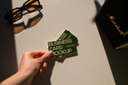 business card mockup PSD with two cards (portrait and landscape) on sunlit desk with plant shadows