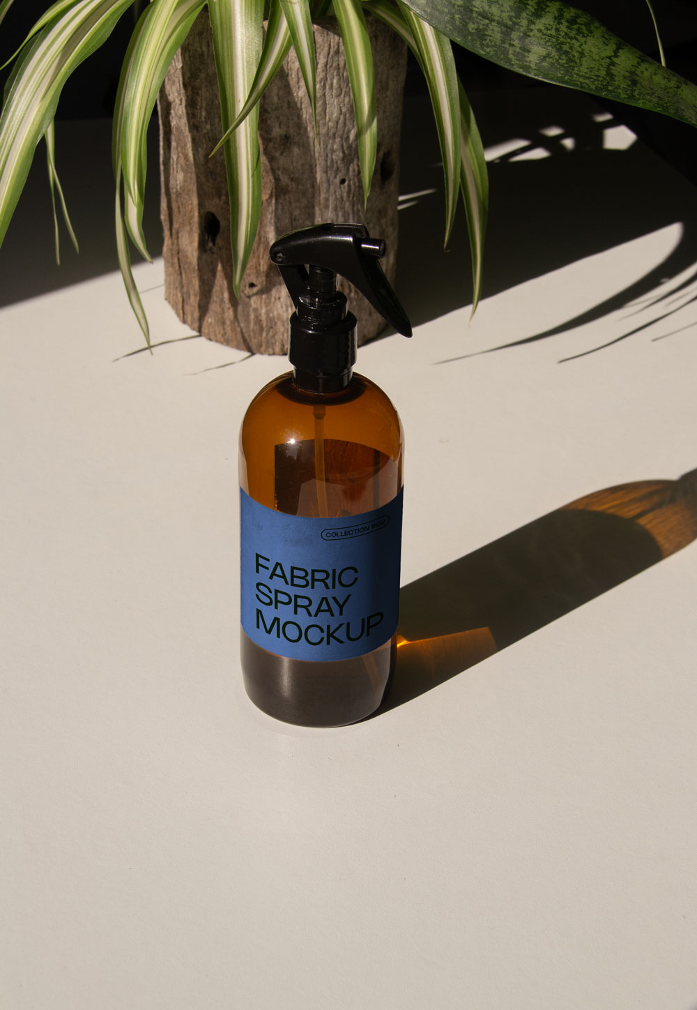 fabric spray bottle label mockup PSD on sunlit table with plant shadows and amber glass