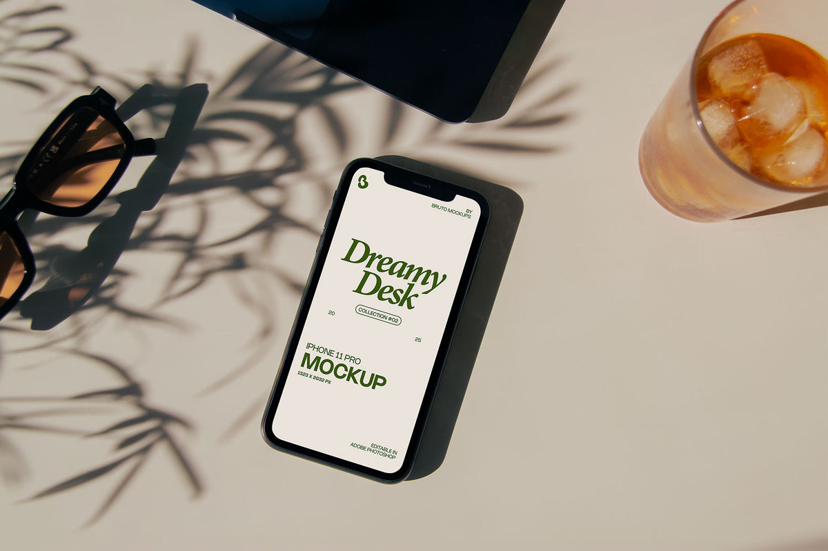 Real photo iPhone mockup PSD on sunlit desk with plant shadows, sunglasses, and iced drink