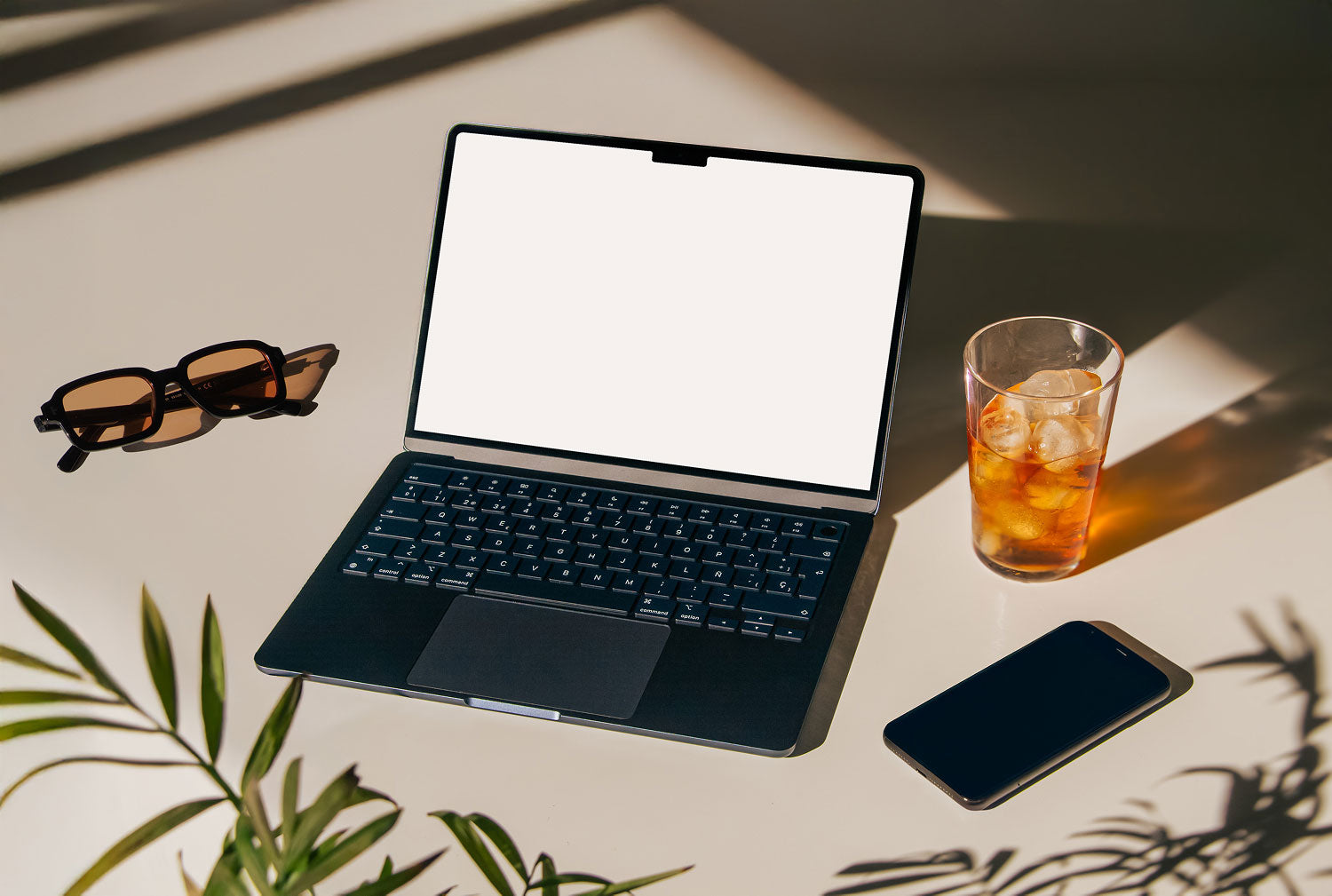 Real photo MacBook Air mockup PSD on sunlit desk with plant shadows, phone and iced drink