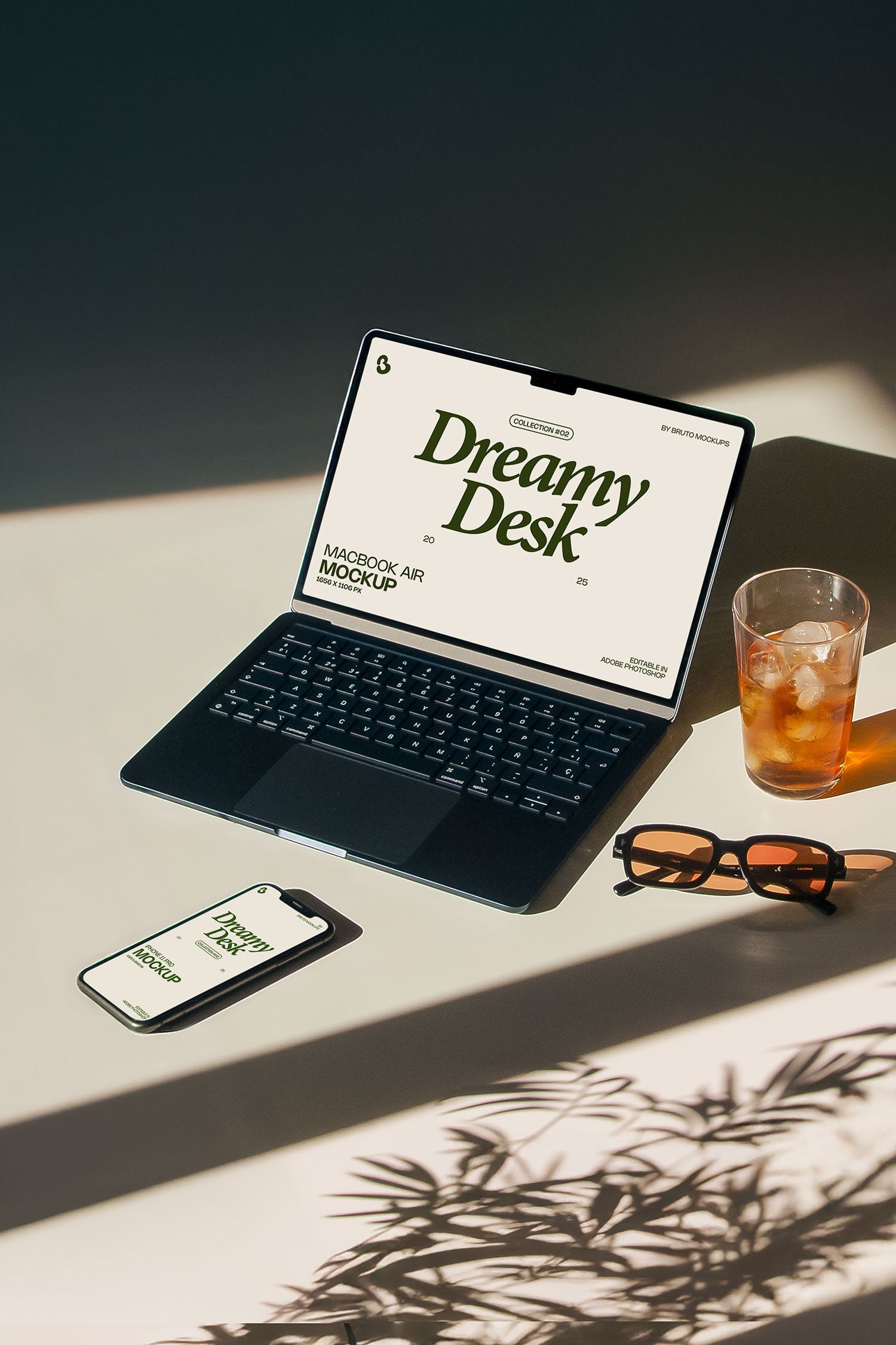 MacBook and iPhone mockup PSD on sunlit desk with plant shadows, sunglasses and iced drink