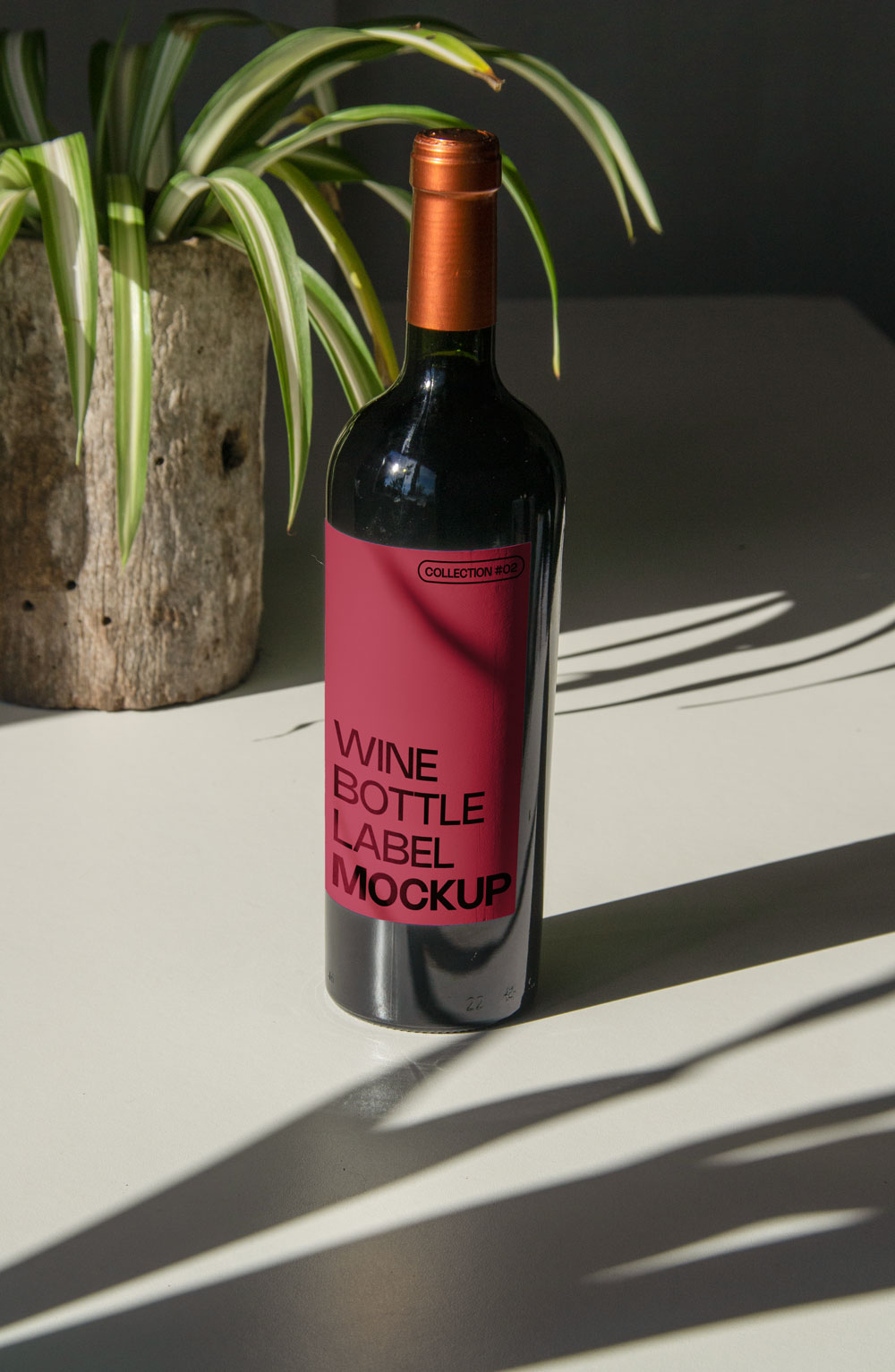 wine bottle label mockup PSD on sunlit table with plant shadows and glass reflections
