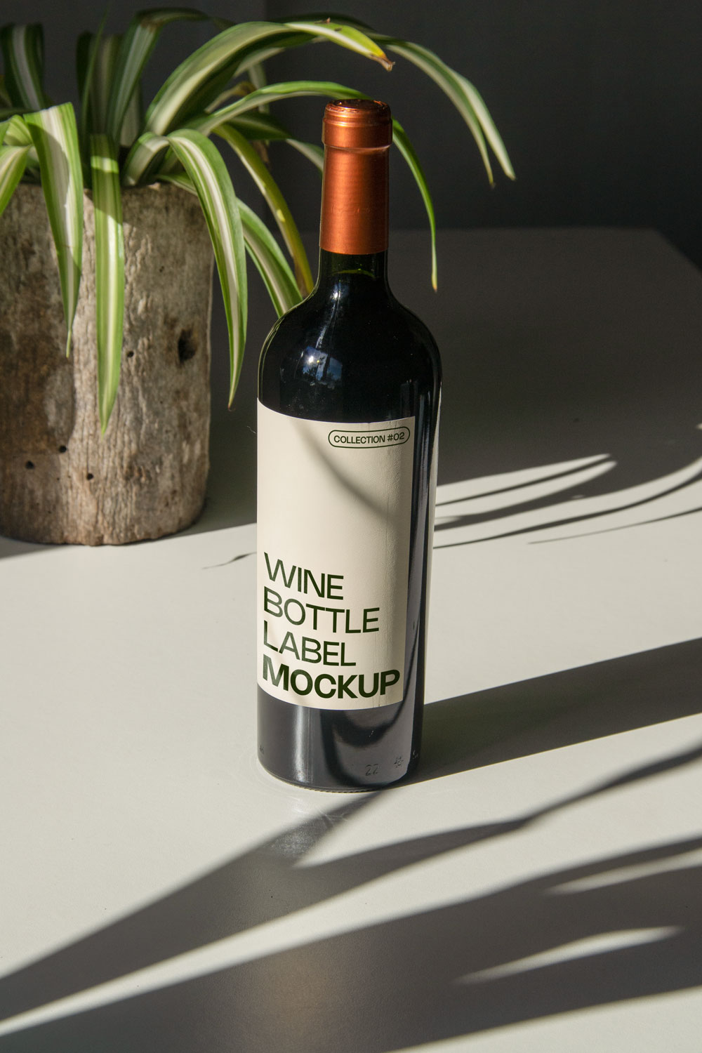 wine bottle label mockup PSD on sunlit table with plant shadows and glass reflections
