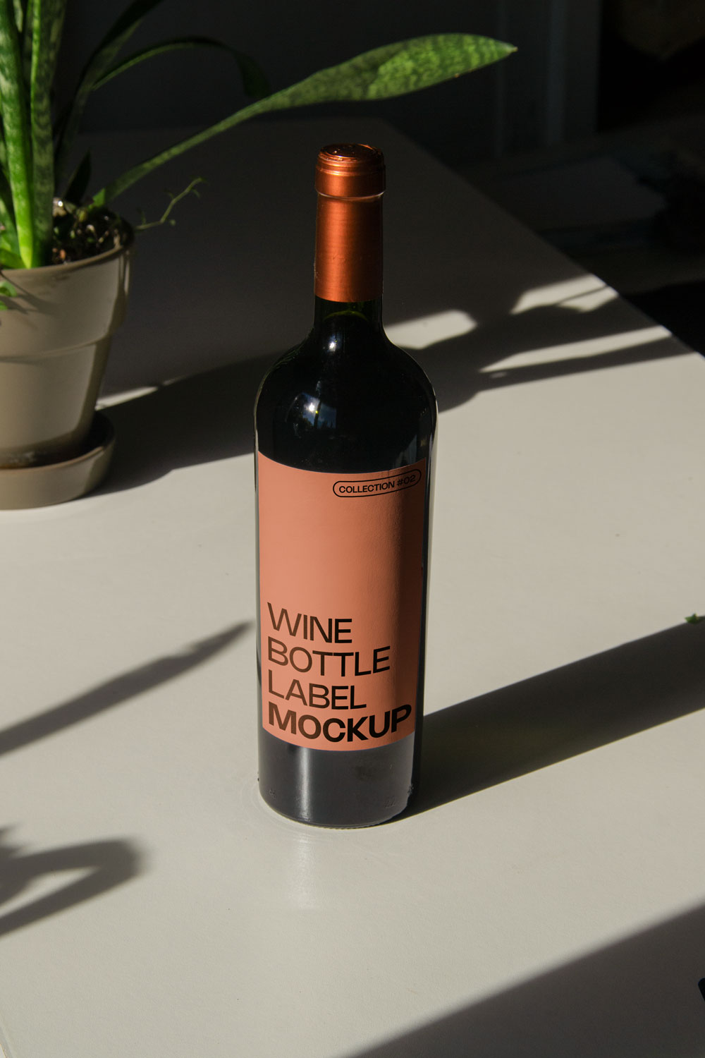 wine bottle label mockup PSD on sunlit table with plant shadows and glass reflections
