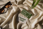 business card mockup PSD with two cards (portrait and landscape) on sunlit desk with plant shadows